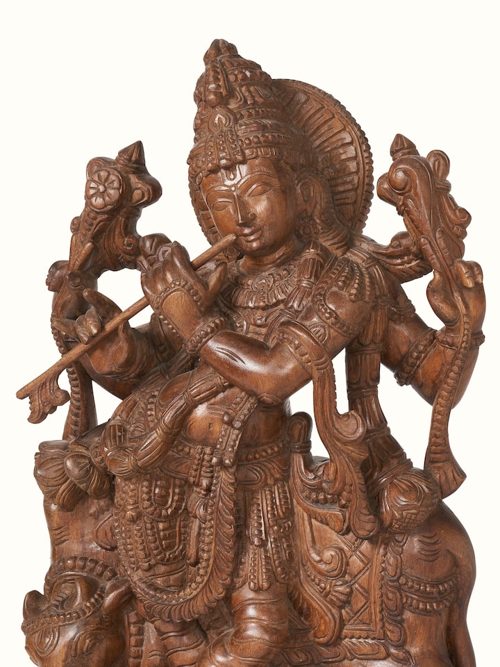Detailed view of Ananta Mara Silai carved Vaagai wood Krishna with flute idol, emphasizing the carving details