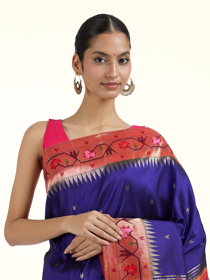Angled view of blue silk Paithani saree highlighting intricate weave