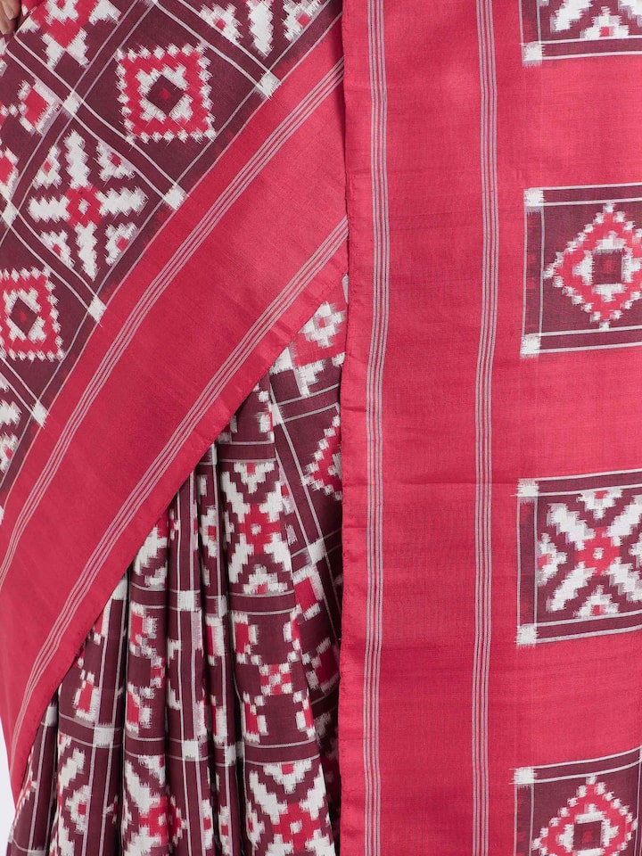 Detail view of red mulberry silk Ikat saree showcasing fine silk texture and resist-dyed craftsmanship