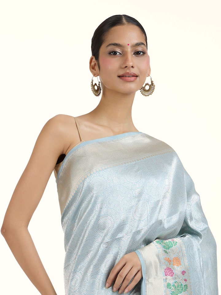 Angled view of Ivory Banarasi Kadhwa Silk Saree revealing the depth of its color and intricate pattern