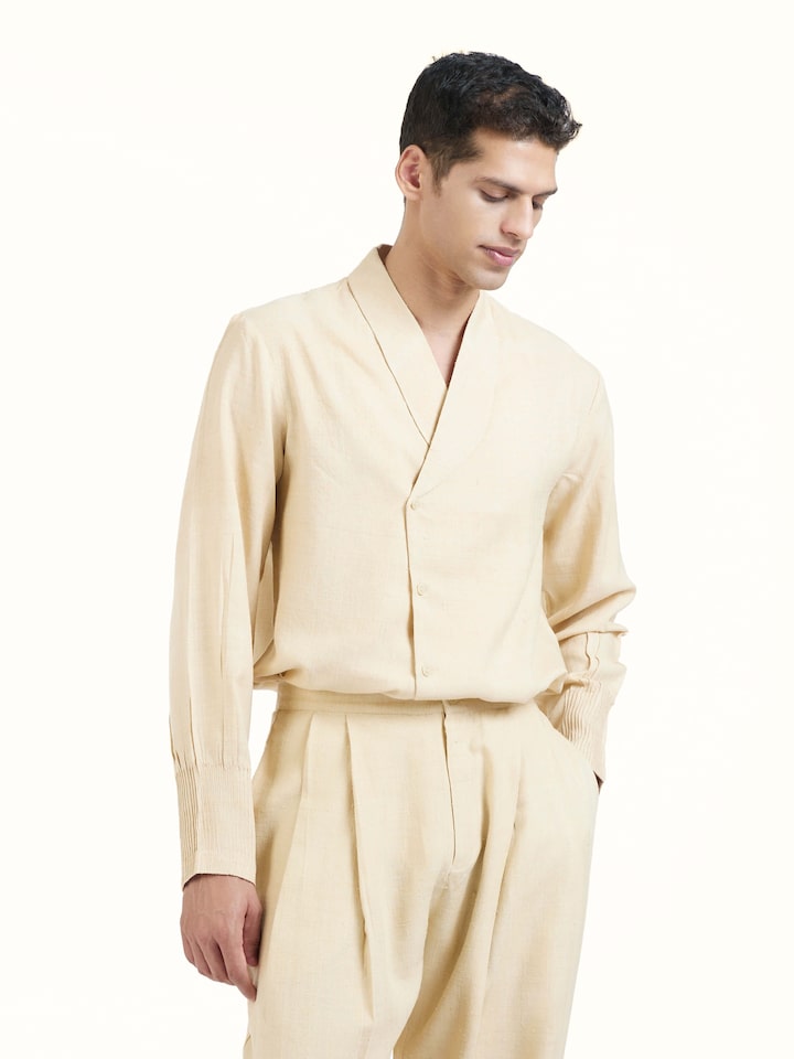 Angled view of off-white silk handloom straight pants highlighting fabric texture
