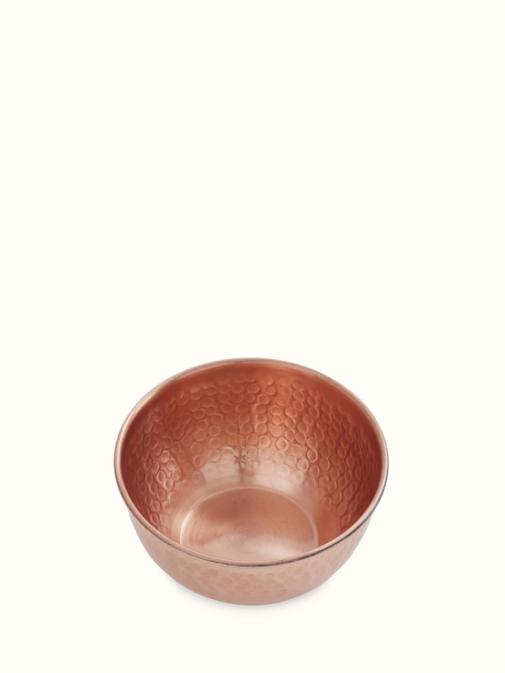 Angle view of Copper Fruit Bowl emphasizing its rounded edges and elegant craftsmanship.
