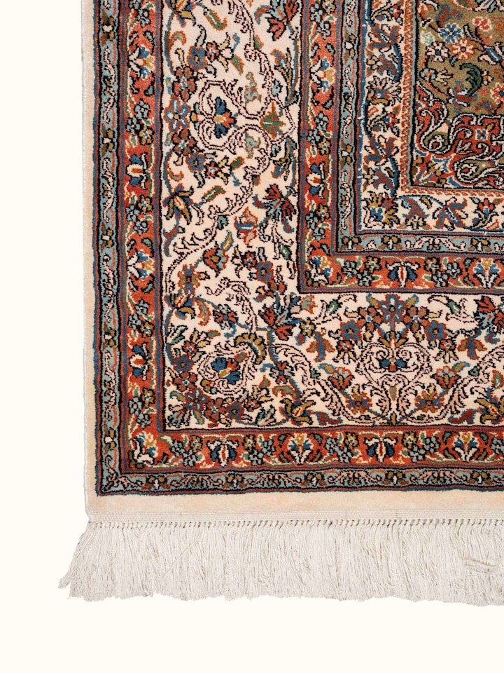 Detail view of Traditional Persian Ivory Green Kerman Kashmir Silk Hand-Knotted Carpet highlighting the intricate pattern and pile texture, from a...