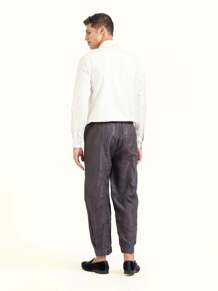 Back view of grey straight quilted tulip pure silk pants displaying overall design