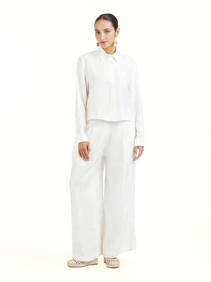 Front view of ivory quilted silk pants with elegant stitching