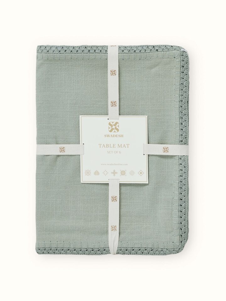 Detail view of Nityam Light Green Cotton Slub Crochet Table Mat (6 Pcs) highlighting the fabric texture and embroidery detail