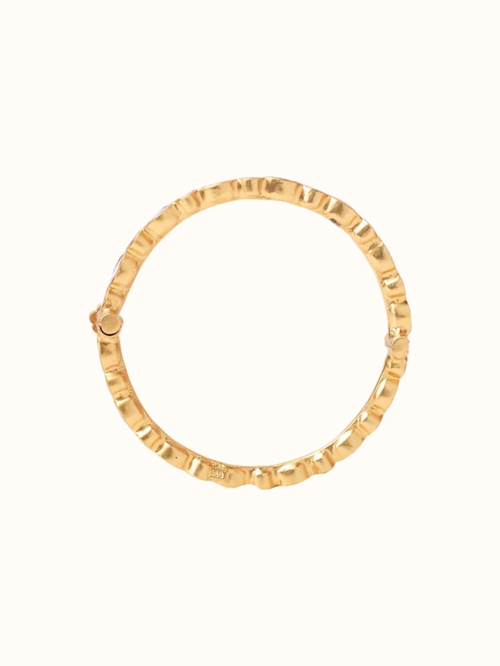 detail view of silver smithing gold plated bangle design