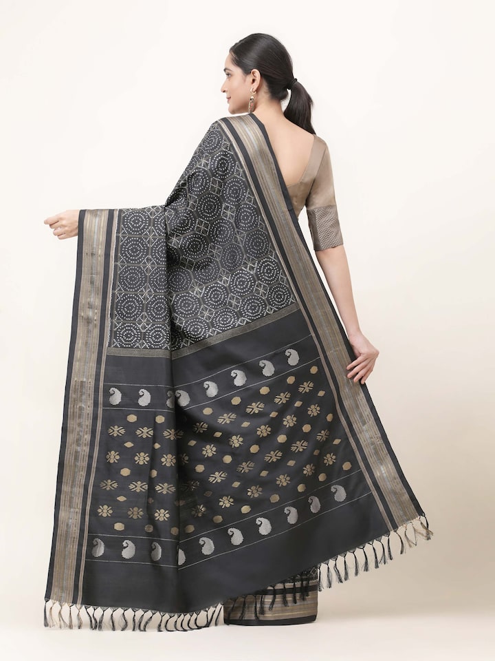 Back view of black silk double Ikat saree showcasing continuous pattern and smooth fall