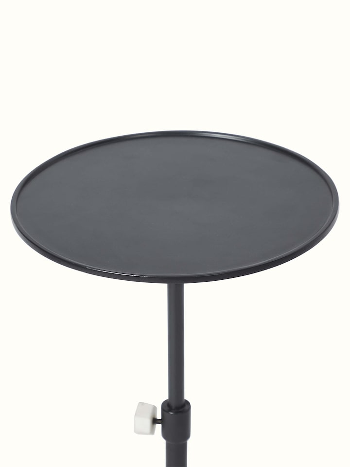 Side view of carved marble & metal end & side table highlighting elegant craftsmanship