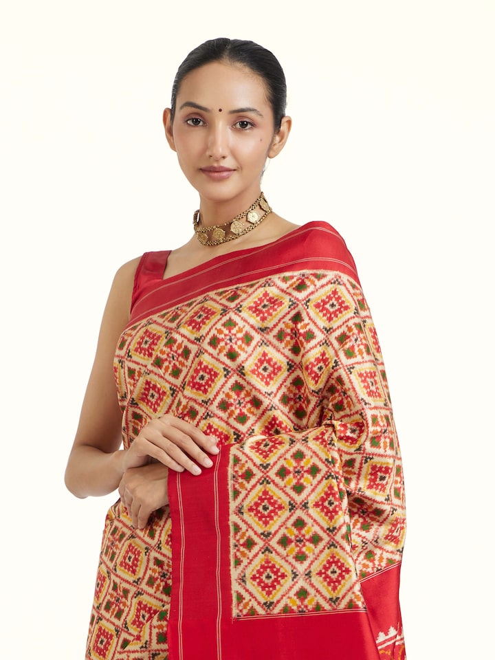 Angled view of Cream Pochampally Double Ikat Silk Saree revealing the depth of its color and intricate pattern