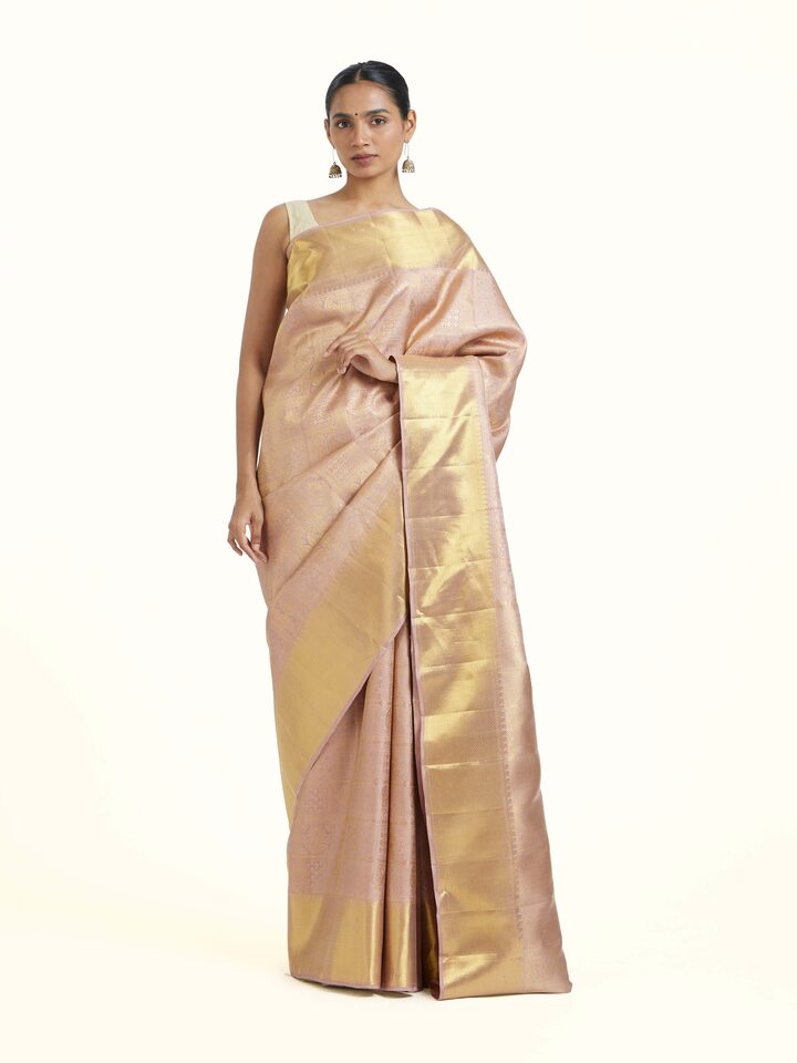 front view of gold kancheepuram silk zari saree with rich detailing