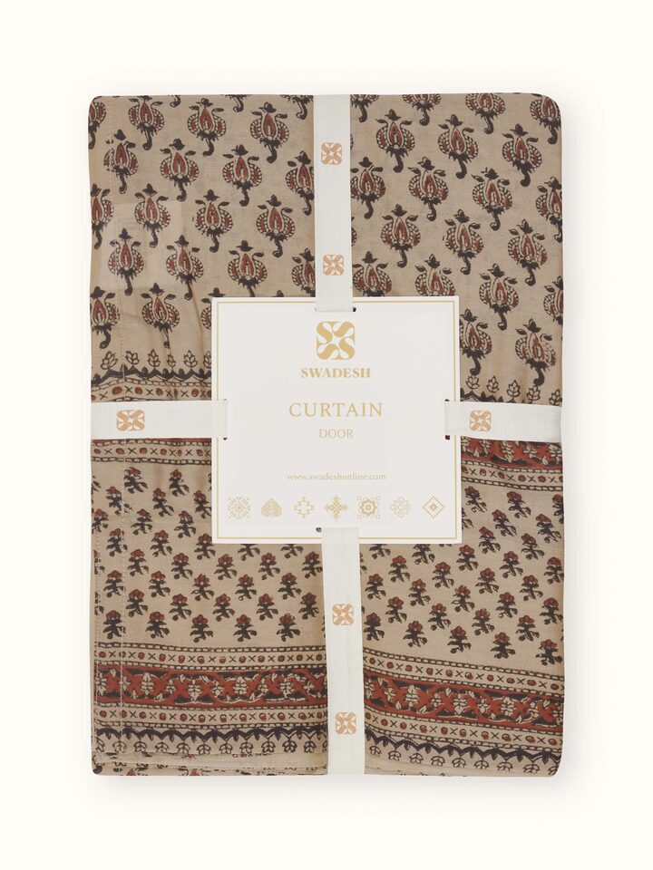 Zoomed-in view of print and fabric texture on Vasudha rust sheer curtain.