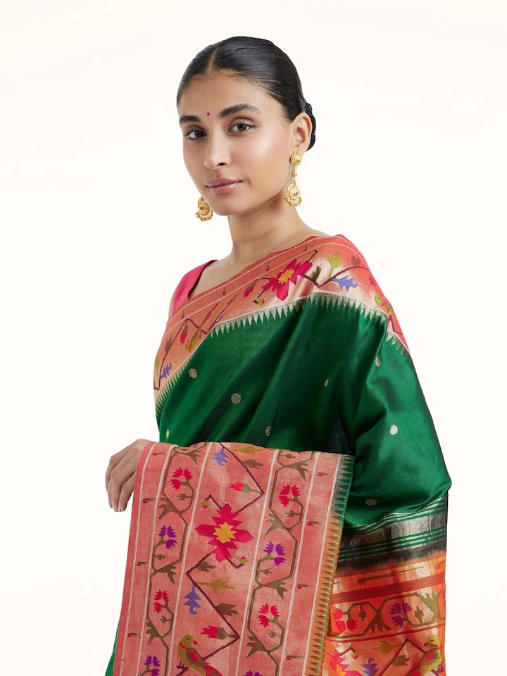 Angled view of green silk Paithani saree emphasizing rich silk texture and weave