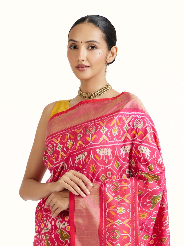Angled view of Light Pink Weft Ikat Silk Saree revealing the depth of its color and intricate pattern