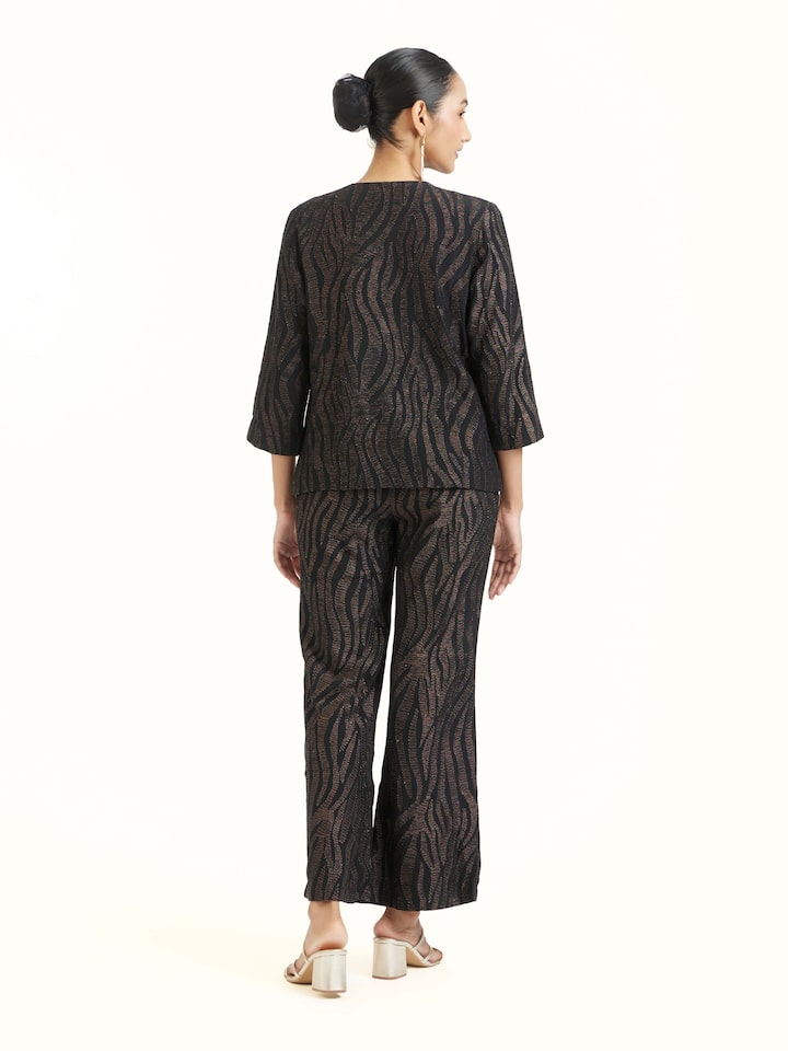 Back view of black Aari hand embroidered pants displaying overall design