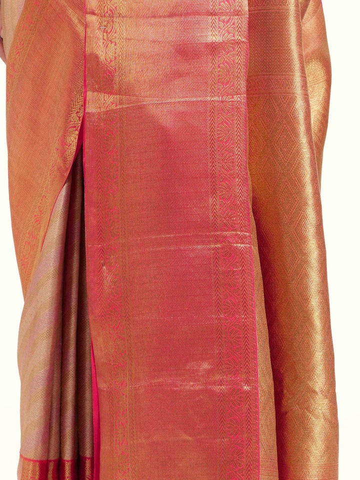Detail view of light pink silk Kancheepuram saree showing smooth silk texture and zari craftsmanship