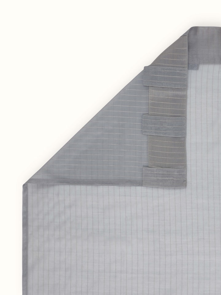 Back view showing sheer fabric and fine handloom detailing of grey metallic stripe curtain.