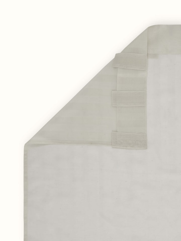 Back view of long ivory Maheshwari curtain showcasing handloom texture and wide stripes.
