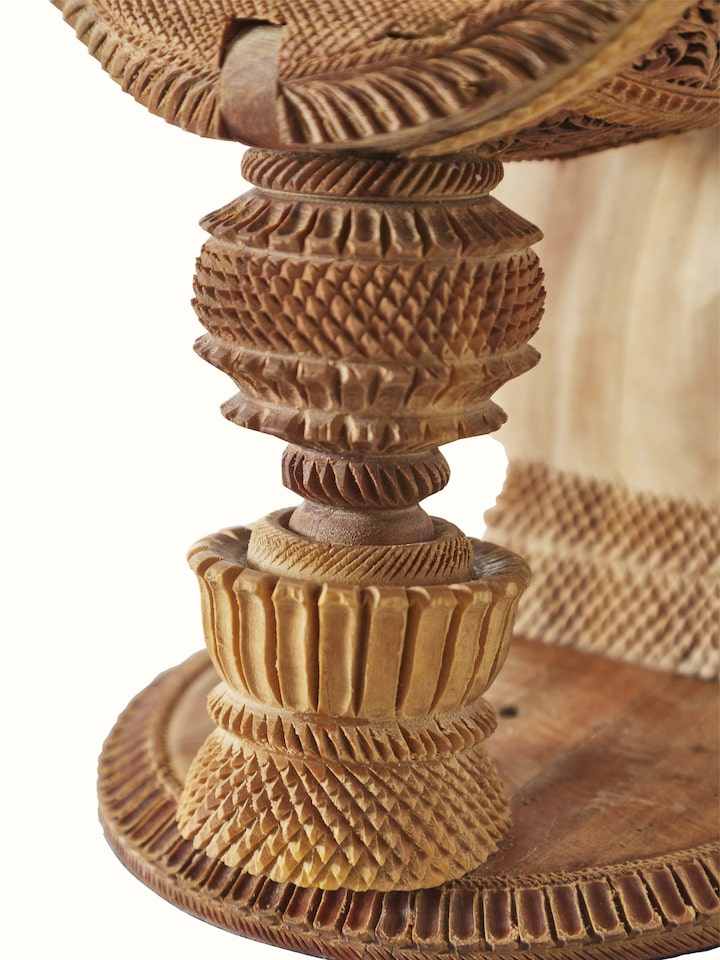 Carved sandalwood veena sculpture with a focus on the artistic design and detailed carvings.