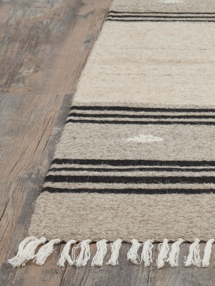 Detailed view of Nomad stripes beige black Jawaja wool & cotton handloom dhurrie (3x5 ft) focusing on the weave and color contrast