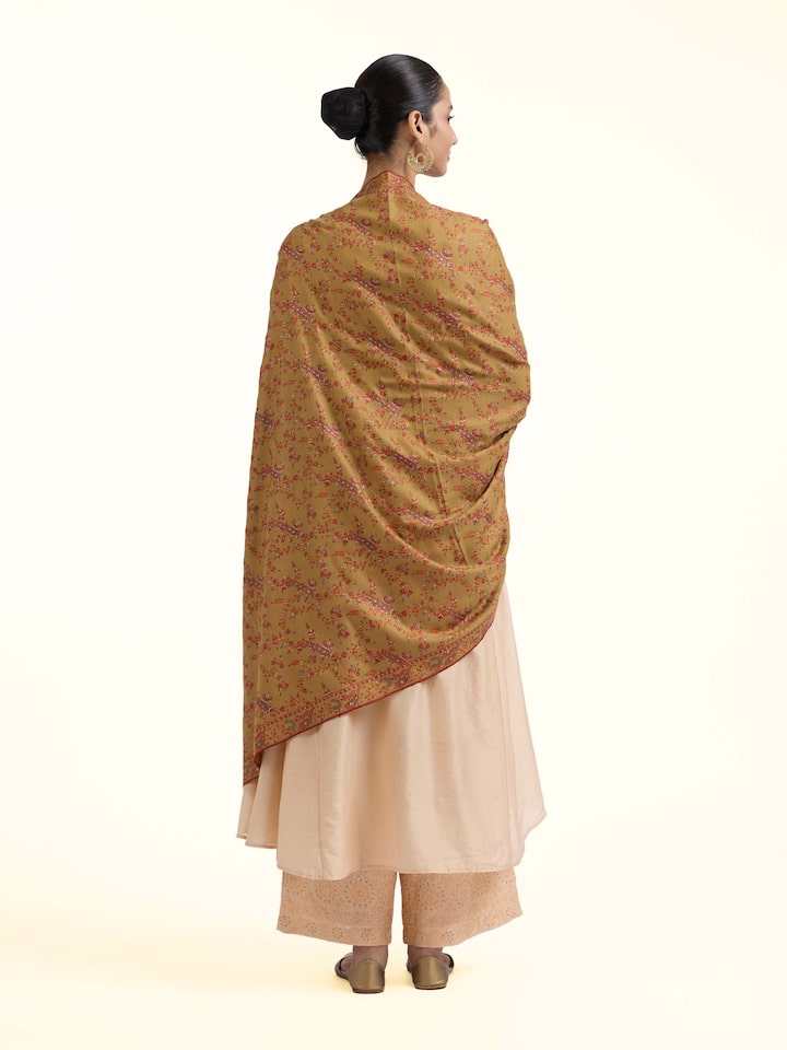 Back view of green jalidar sozni embroidered shawl displaying complete design