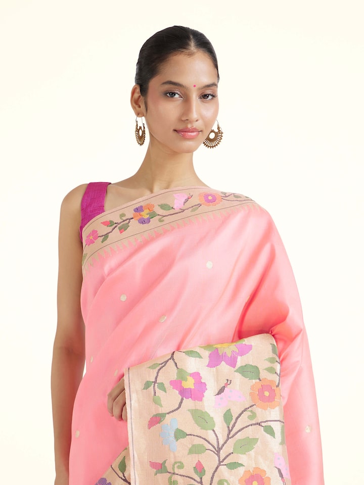 Angled view of pink silk Paithani saree highlighting intricate weave