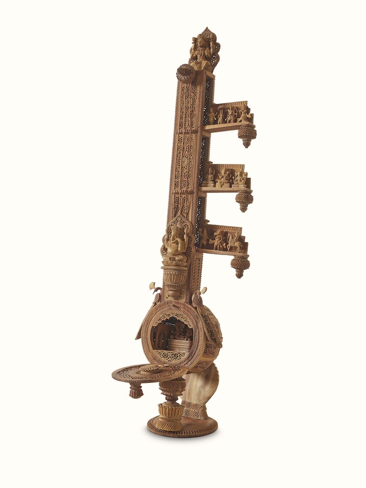 Detailed view of carved sandalwood veena sculpture, showing the fine carvings and artistic design.