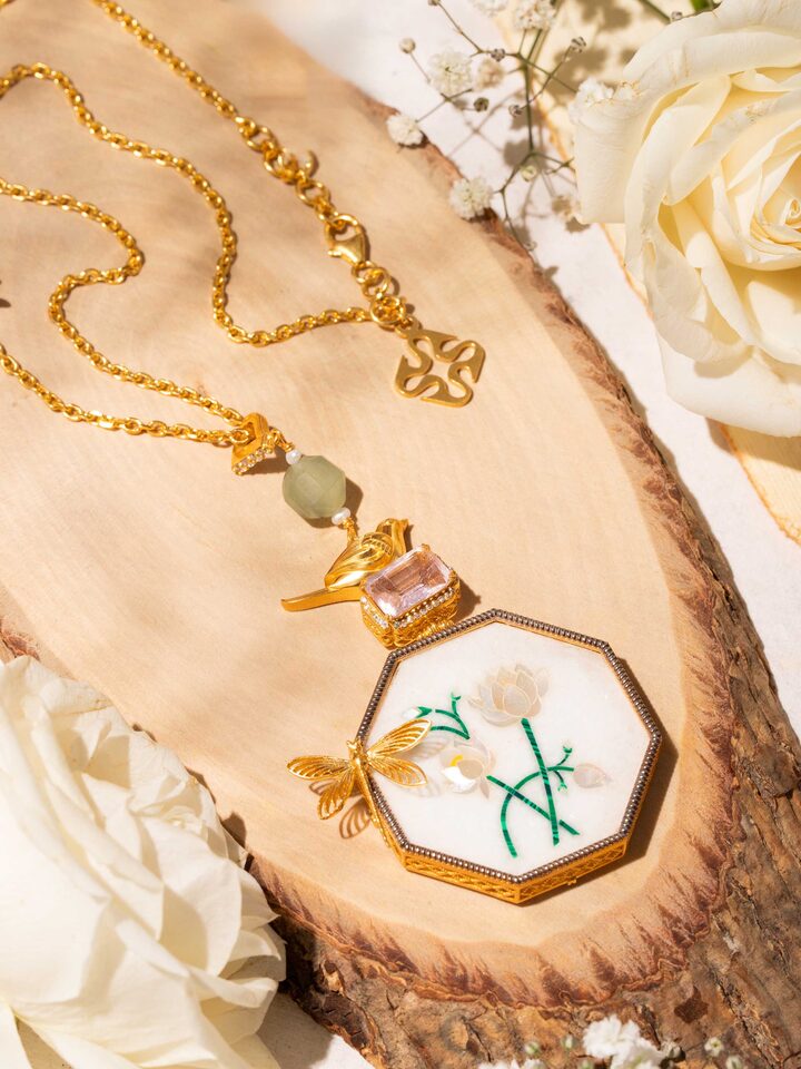 Styled detail view of Parchinkari Silver Pendant & Chain worn around the neck, shown in another styled shot