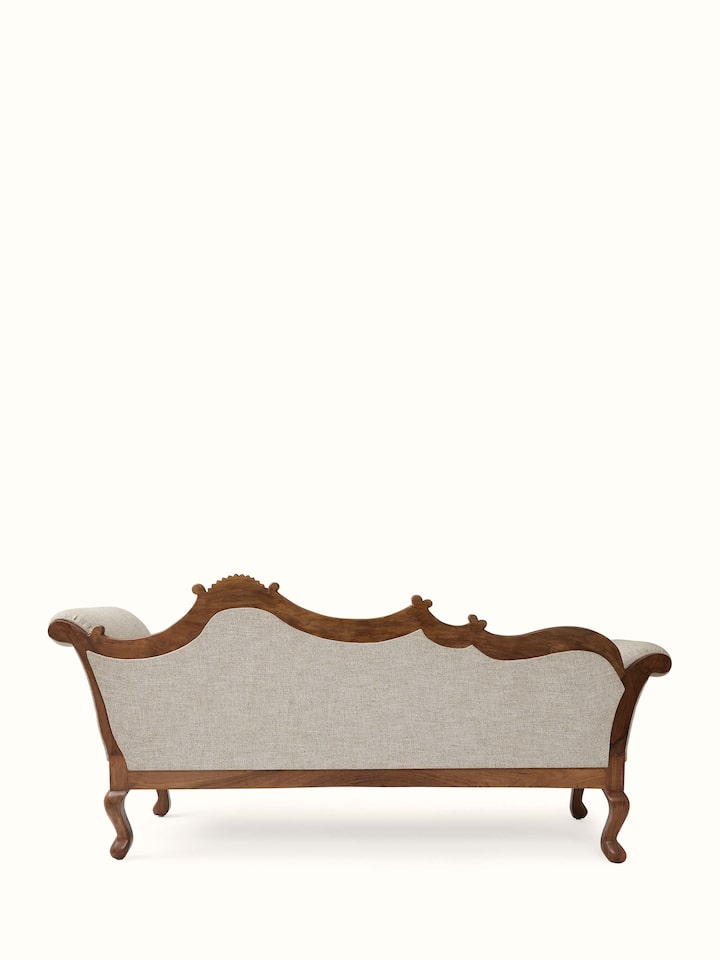 Detailed view of the handloom fabric upholstery on the carved walnut wood daybed, emphasizing the texture and design of the fabric