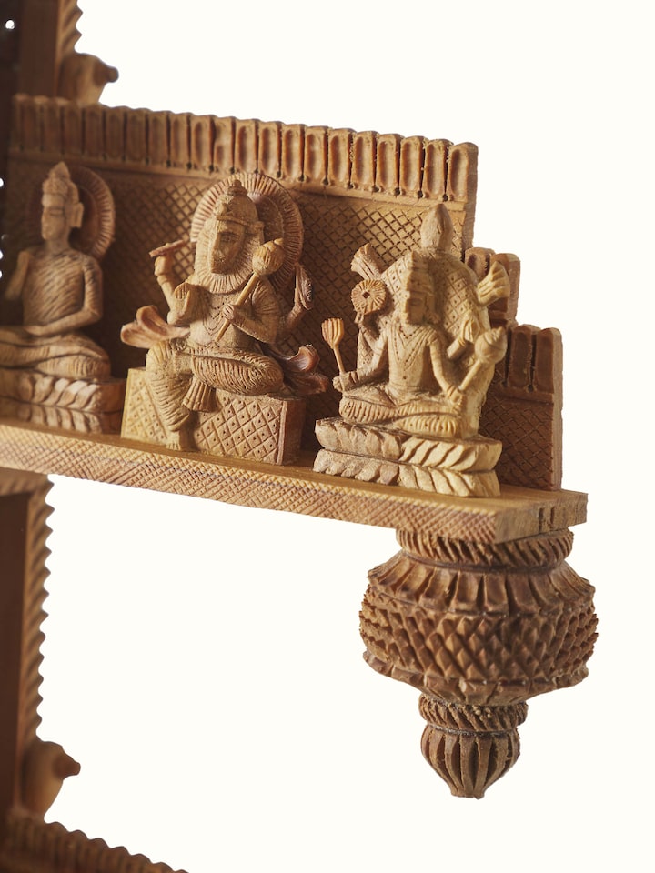 Close-up view of carved sandalwood veena sculpture, highlighting the fine detailing and artistic workmanship.
