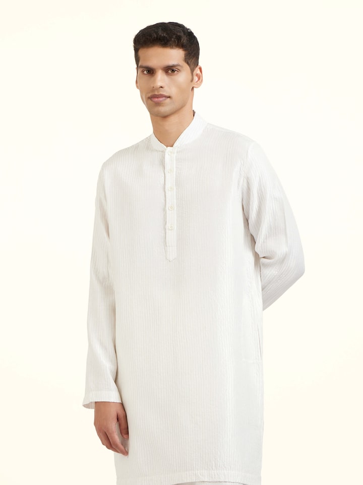 Angled view of white silk quilting short kurta highlighting quilted texture and sheen