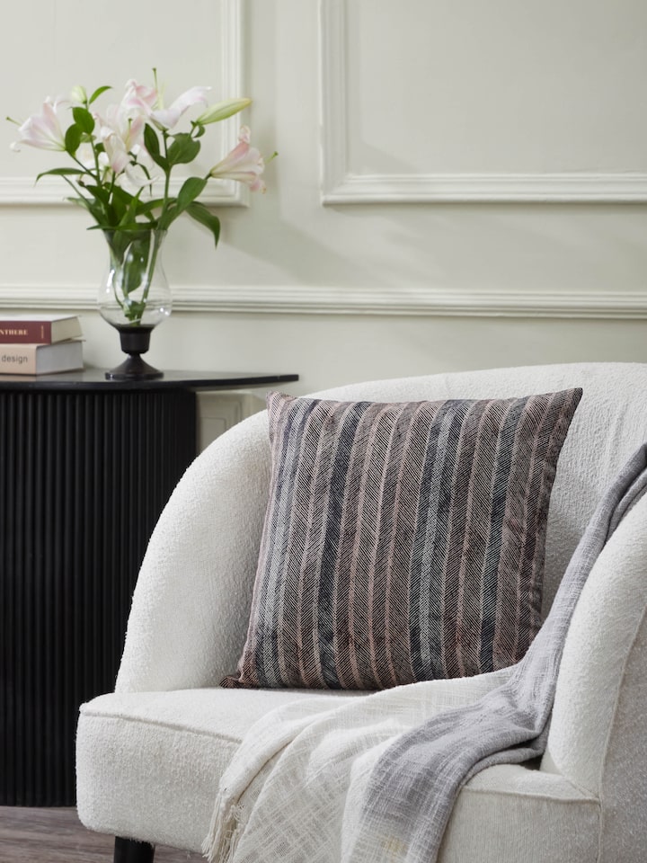 Sofa styling scene showing Parvat cushion cover adding earthy tones and texture.