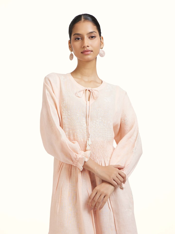 Close-up view of Peach Linen Chikankari Dress highlighting the fabric texture and embroidery detail