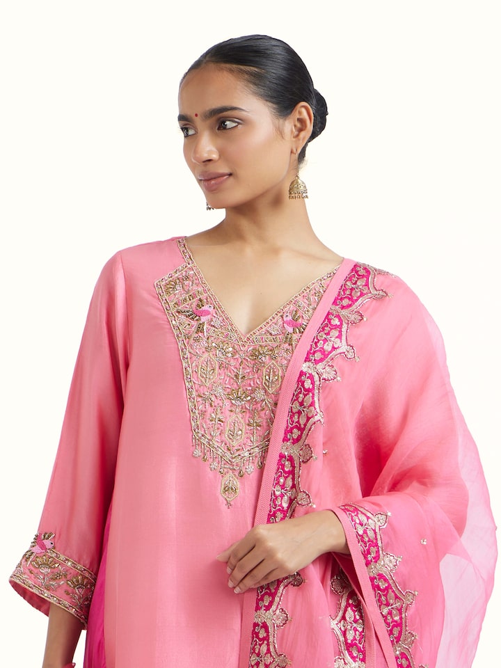 Angled view of Pink Zardozi Silk Kurta Set (3 Pcs) revealing the depth of its color and intricate pattern