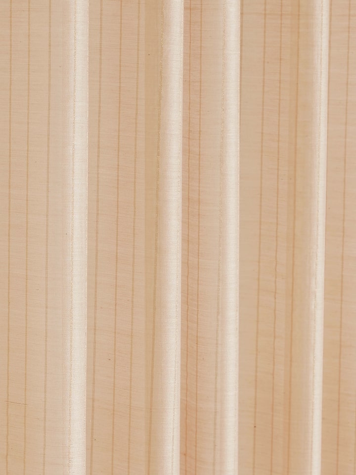 Detail shot showing metallic stripe accents on handwoven beige Maheshwari sheer curtain fabric.