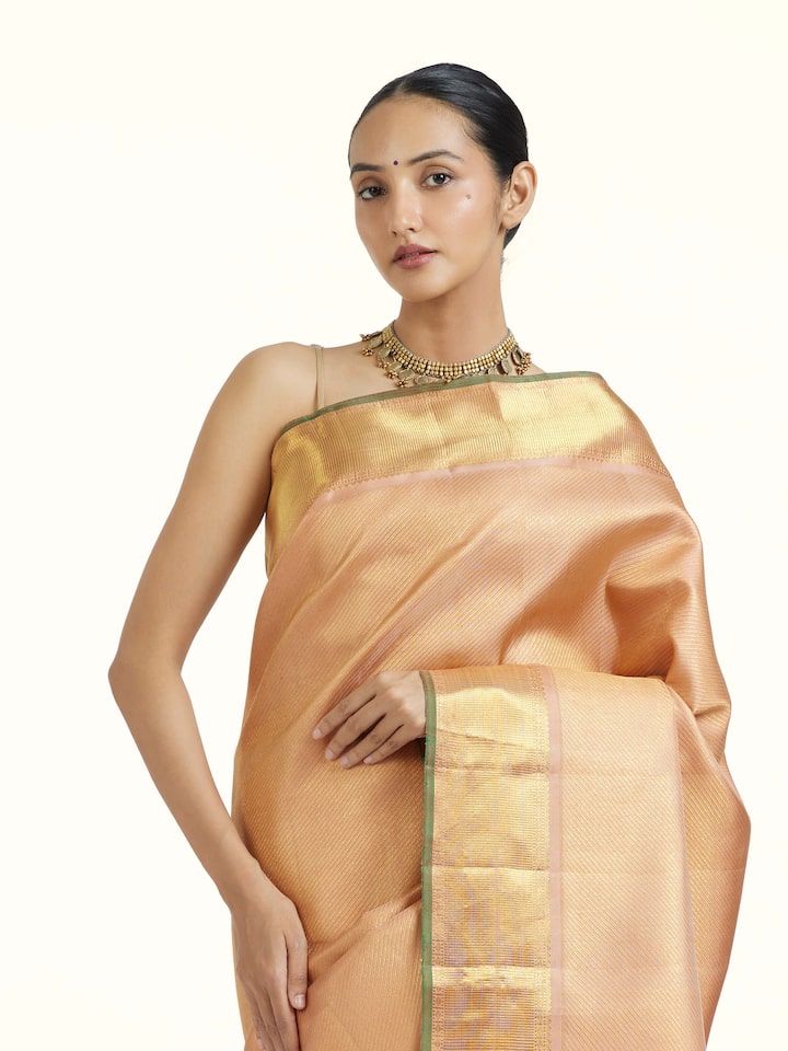 Angled view of Pink Kancheepuram Silk Zari Saree revealing the depth of its color and intricate pattern