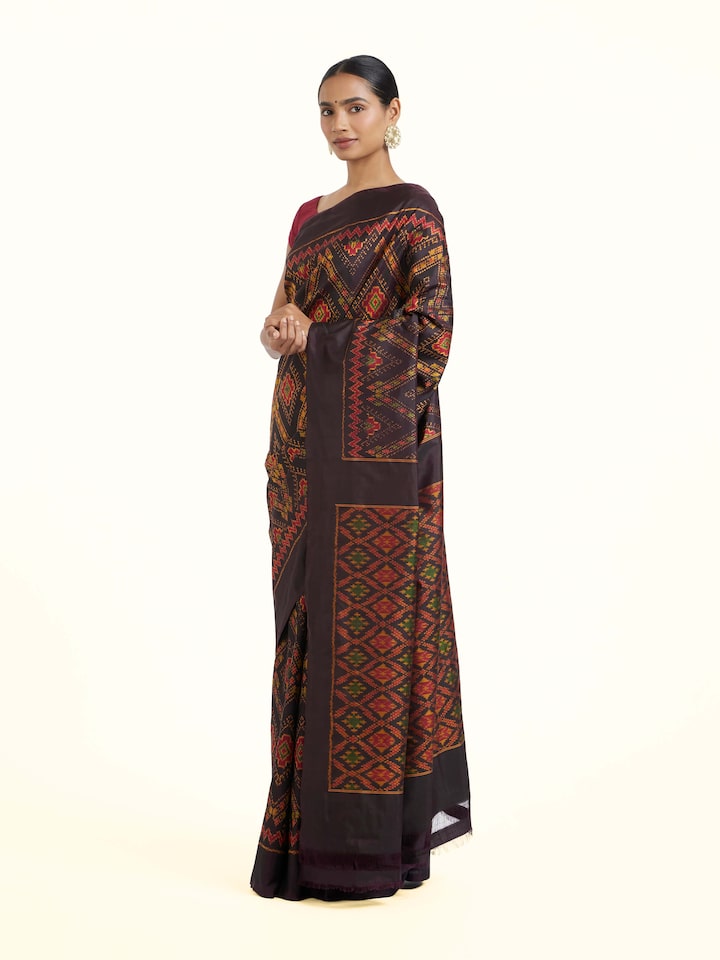 Side view of Brown Pochampally Combodia Ikat Silk Saree highlighting the detailed craftsmanship and elegant silhouette