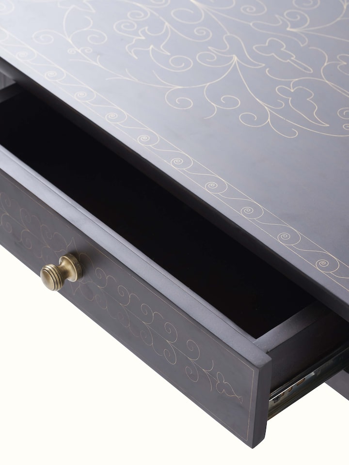 Detailed view of the brass inlay work on the Sheesham wood console table, emphasizing the fine craftsmanship.