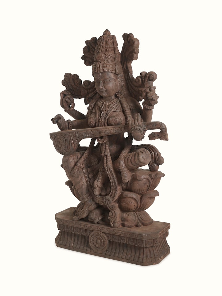 Angled view of the Wood Carved Sitting Saraswati Idol