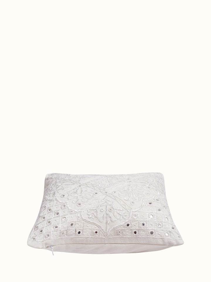Angled view of Lippan white embroidered cotton cushion cover