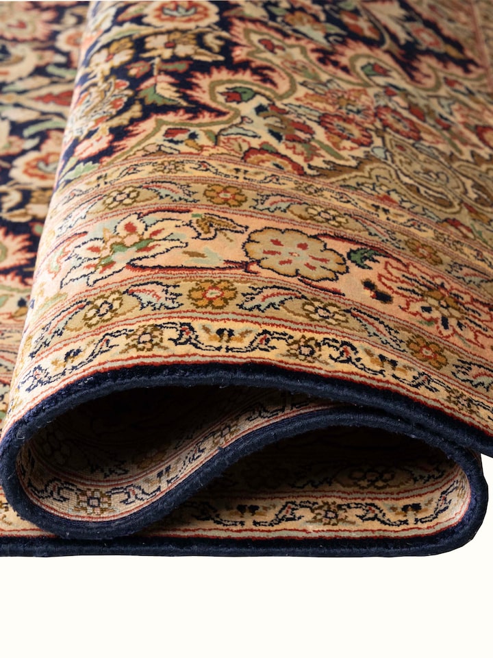 Detail view of Traditional Persian Navy Kashan Kashmir Silk Hand-Knotted Carpet highlighting the intricate pattern and pile texture, from a differe...