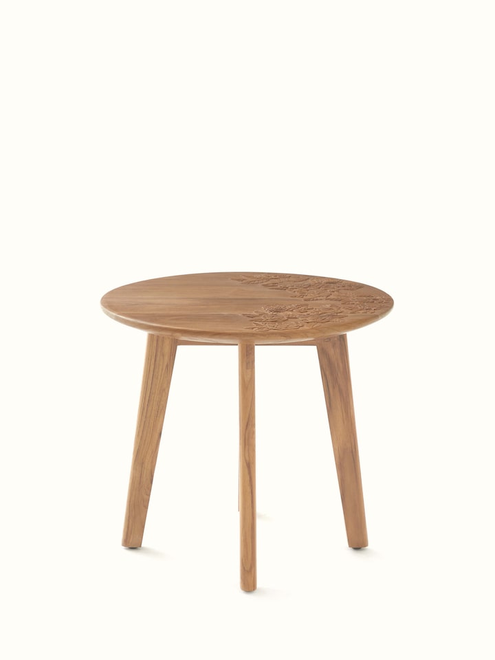 Front view of the carved teak wood round side table, showcasing intricate detailing and craftsmanship