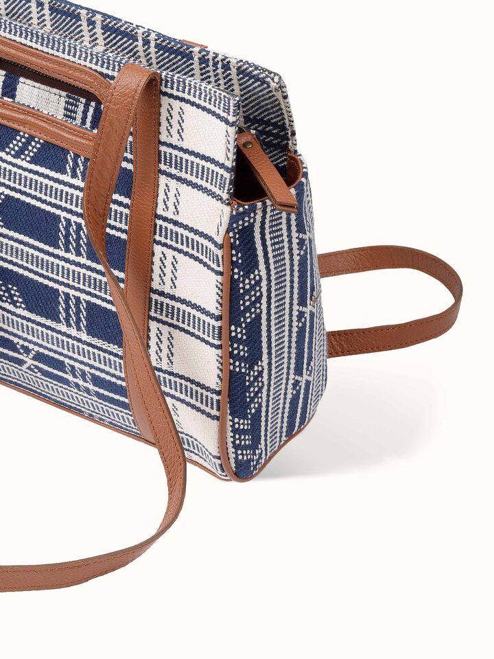 Overhead view of sling bag displaying shape, texture, and strap placement.