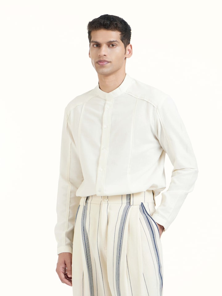 Angled view of ivory cotton handloom straight pants highlighting handwoven texture