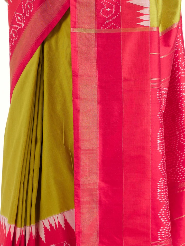 Detail view of mustard mulberry silk ikat saree showing silk texture