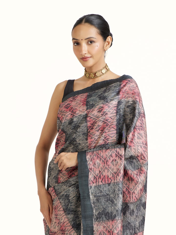 Angled view of Black Tussar Silk Discharge Block Printed Saree revealing the depth of its color and intricate pattern