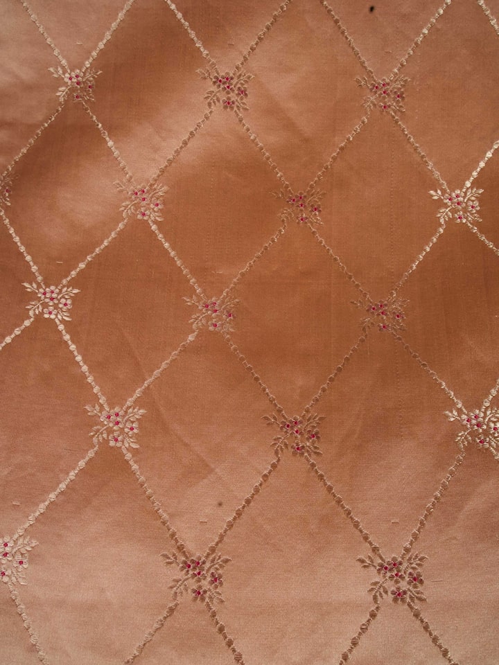 Close-up of brocade weave detail on Naman peach silk table runner