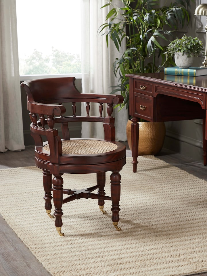 Side view of Mahogany wood and cane study chair showcasing tapered legs and ergonomic structure