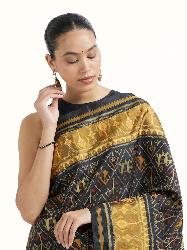Angled view of Rajkot Patola Ikat Saree revealing the depth of its color and intricate pattern