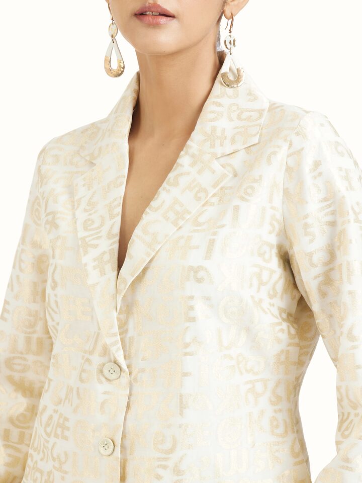 Detail view of ivory handloom cut work calligraphy co-ord set showcasing fine craftsmanship